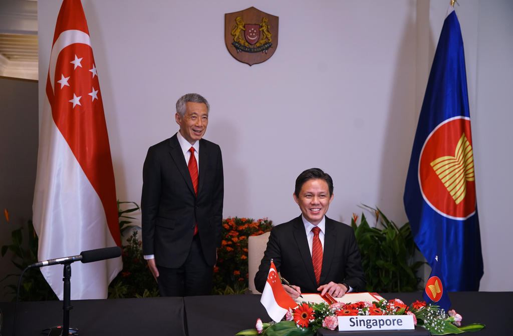 Singapore Trade and Industry Minister Chan Chun Sing signing the RCEP agreement, witnessed by Prime Minister Lee Hsien Loong November 15, 2020. u00e2u20acu201d Singapore Ministry of Communications and Information pic via TODAY