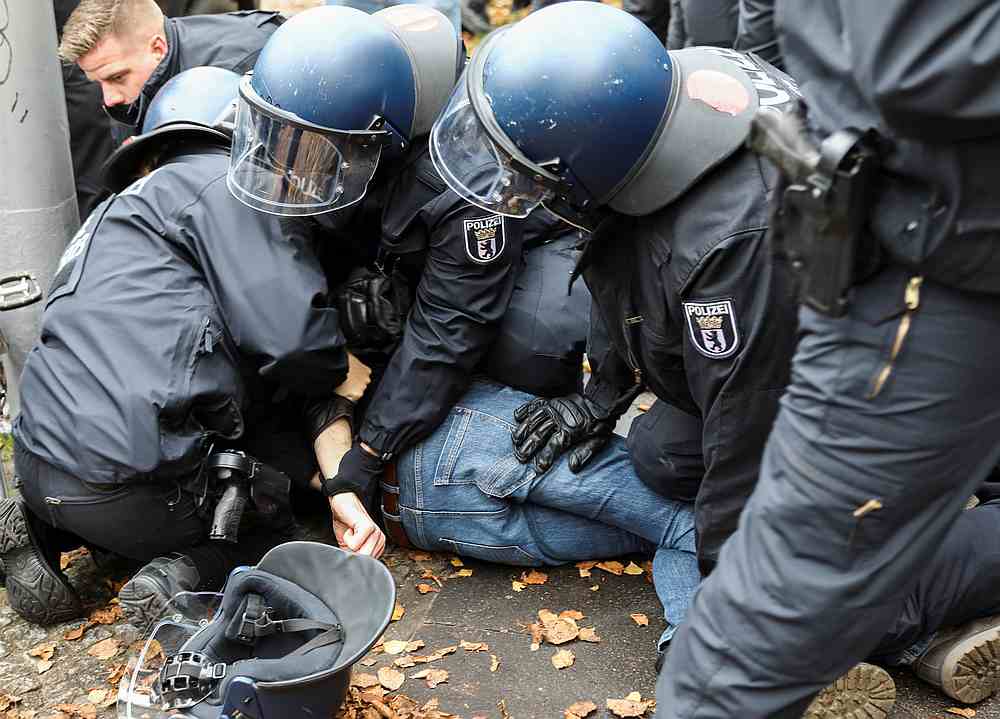 Police officers try to remove a counter-protester from a street during a demonstration against the government's Covid-19 restrictions in Berlin, Germany November 22, 2020. u00e2u20acu201du00e2u20acu201d Reuters pic 