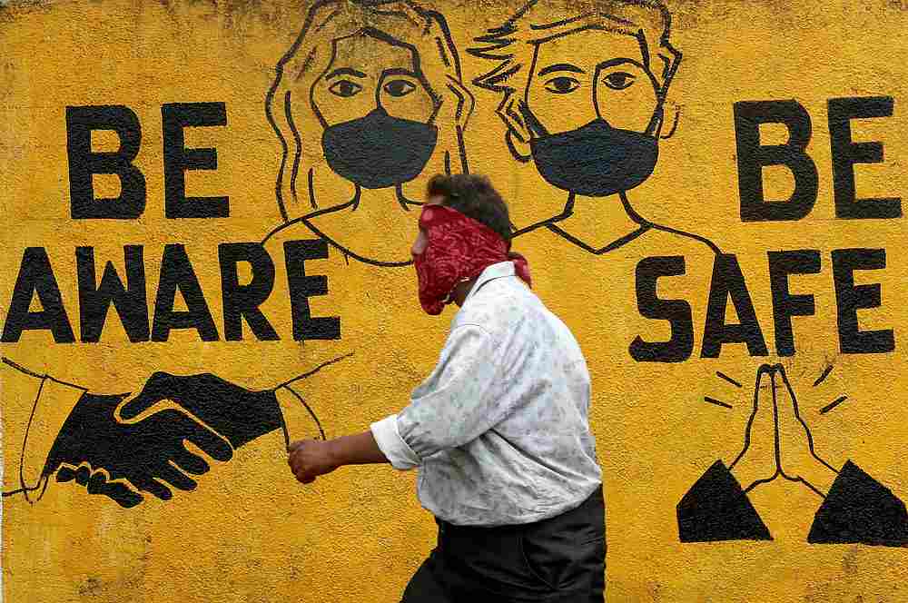 A man walks past a graffiti amid the spread of Covid-19 in Mumbai, India November 2, 2020. u00e2u20acu201d Reuters pic