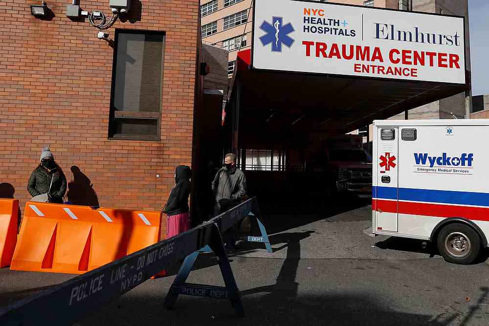 People wearing protective face masks wait in line at a mobile Covid-19 testing unit at Elmhurst Hospital in the Queens borough of New York November 19, 2020. u00e2u20acu201d Reuters pic