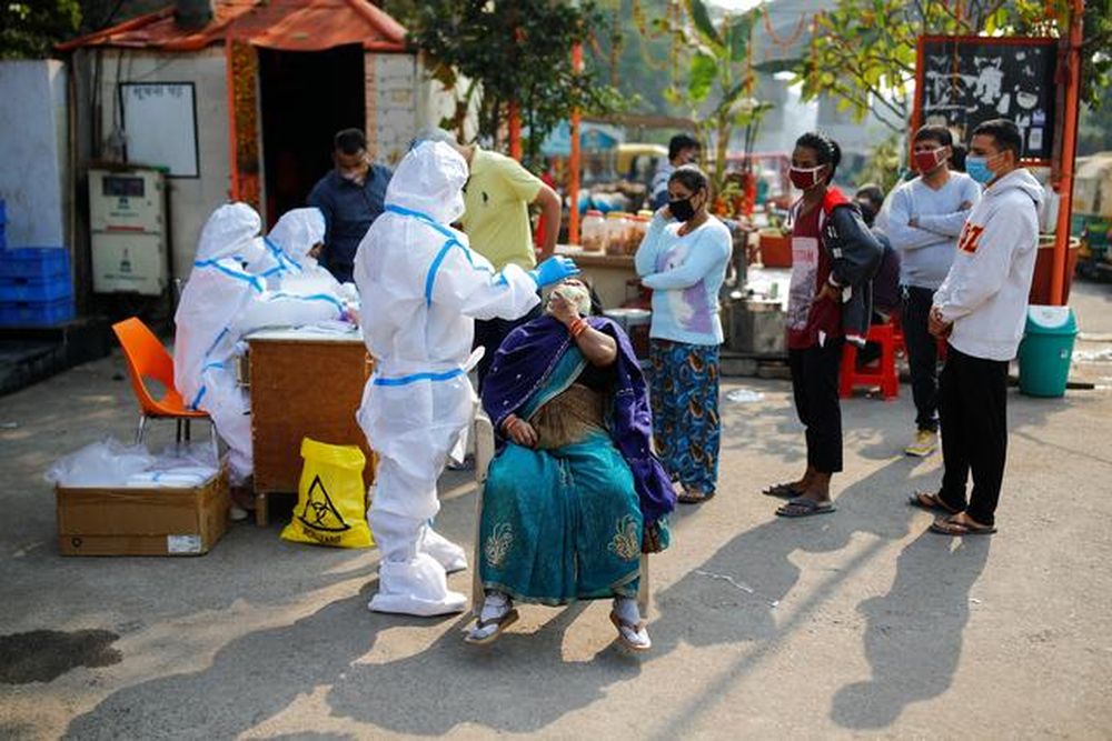 A healthcare worker wearing personal protective equipment (PPE) collects a swab sample from a woman amidst the spread of the coronavirus disease, at Delhi-Uttar Pradesh border, in Noida, India, November 19, 2020. u00e2u20acu201d Reuters pic