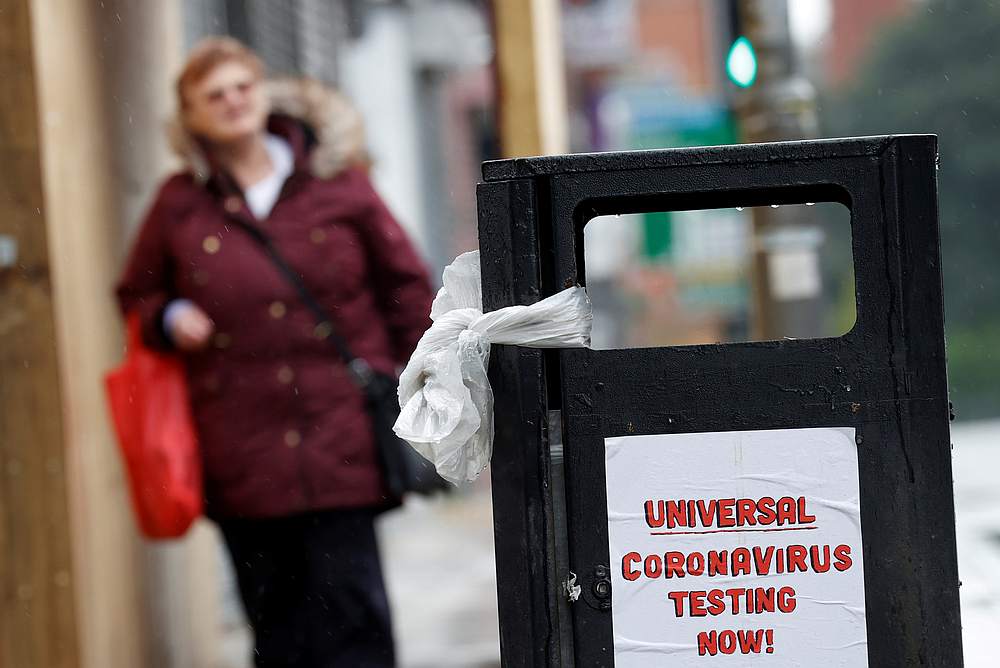 A poster reading 'Universal Coronavirus Testing Now!' is seen on a bin in Liverpool, Britain April 18, 2020. u00e2u20acu201d Reuters pic 