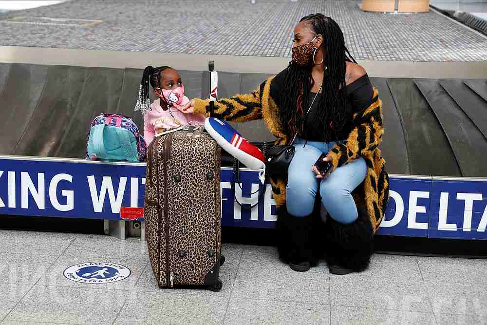 Chrissy and her daughter Ari (last names withheld) wait for their baggage after travelling from New Jersey to Hartsfieldu00e2u20acu201cJackson Atlanta International Airport ahead of the Thanksgiving holiday, in Atlanta, Georgia,November 23, 2020. u00e2u20acu201d Reuters pic