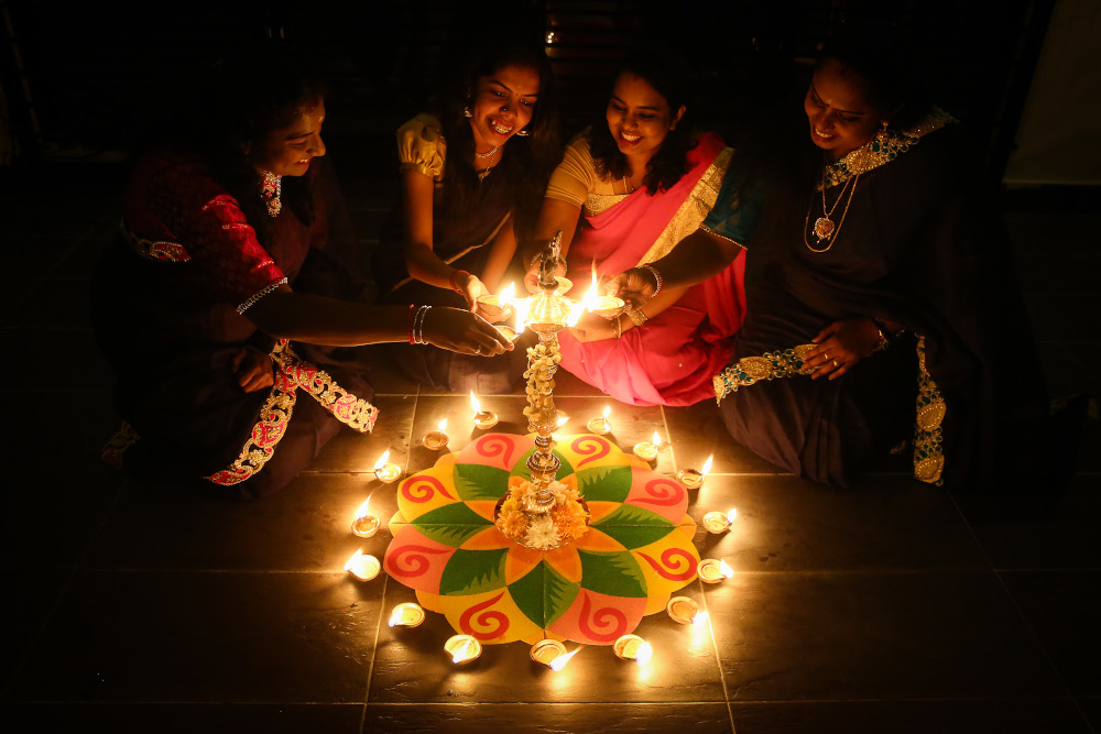 Women light oil lamps ahead of Deepavali celebrations at their residence in Shah Alam, November 12, 2020. u00e2u20acu201d Picture by Yusof Mat Isa