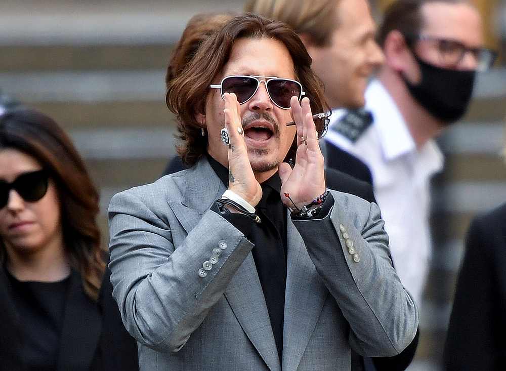 Actor Johnny Depp gestures as he leaves the High Court in London, Britain July 28, 2020. u00e2u20acu201d Reuters pic 
