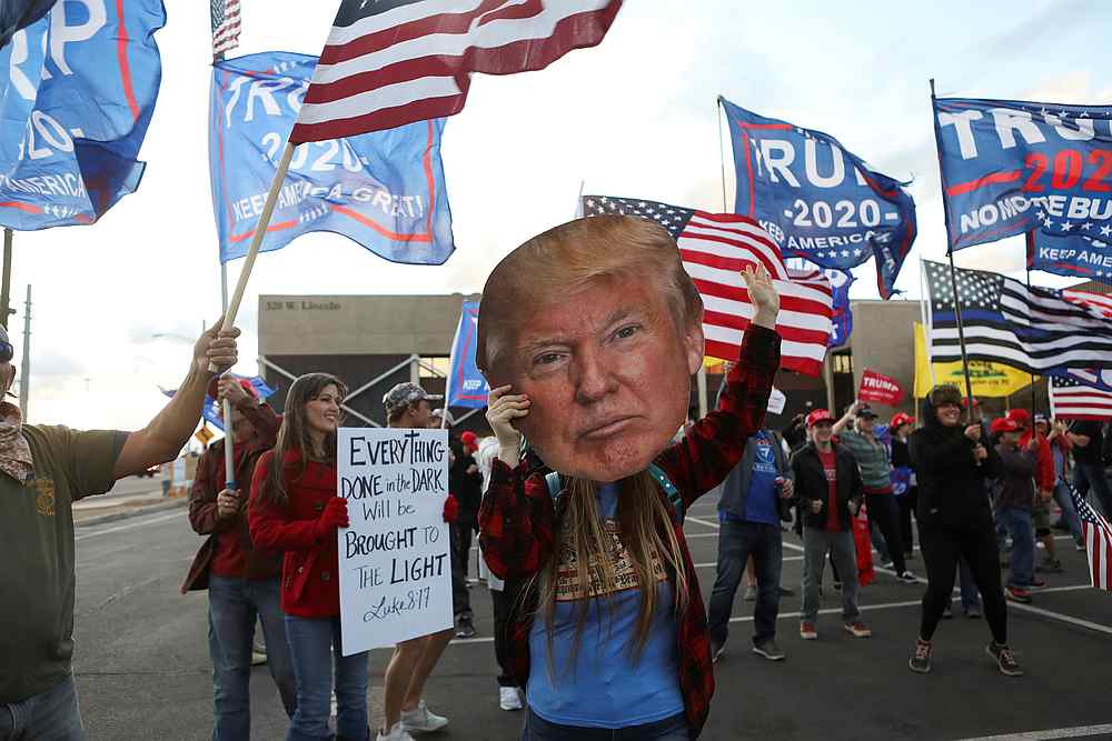 A woman holds a cutout of US President Donald Trump's head as supporters gather at a 'Stop the Steal' protest in front of the Maricopa County Tabulation and Election Center (MCTEC), in Phoenix, Arizona November 8, 2020. u00e2u20acu201d Reuters pic