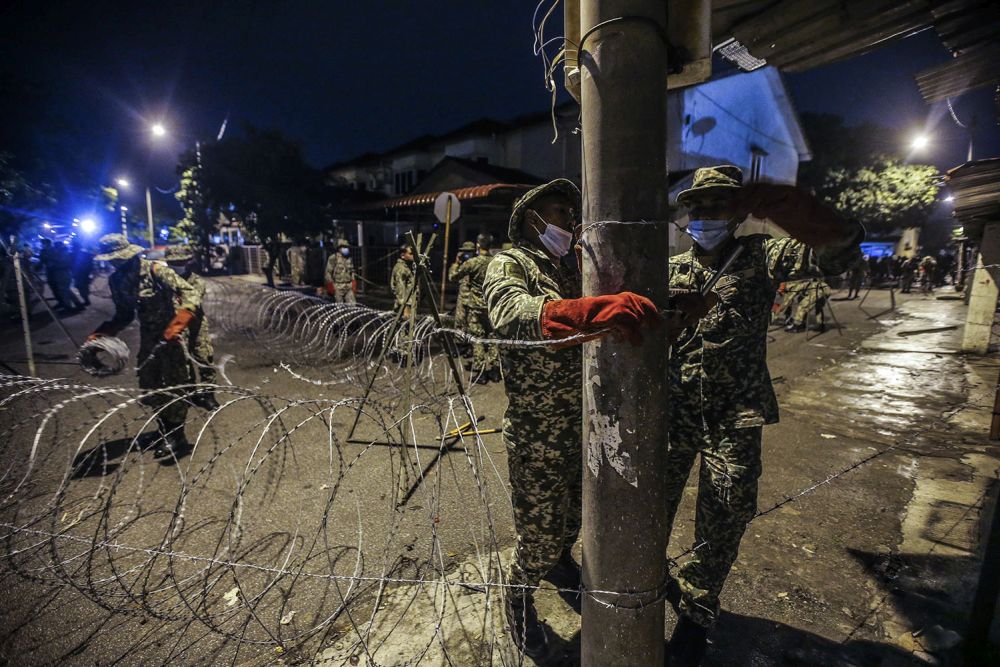 Malaysian Armed Forces personnel install barbed wire fencing at Top Gloveu00e2u20acu2122s male and female staff dormitories in Klang in November 16, 2020. u00e2u20acu201d Picture by Hari Anggara