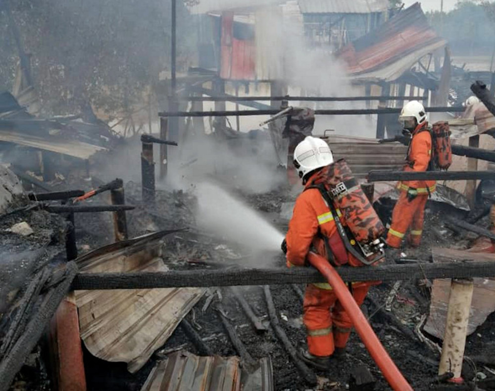 Fire and Rescue personnel putting out the fire at a semi-permanent squatter house near Sungai Pontian Besar in Kampung Sri Dungun, near Pontian, November 9, 2020. u00e2u20acu201d Bernama picnn