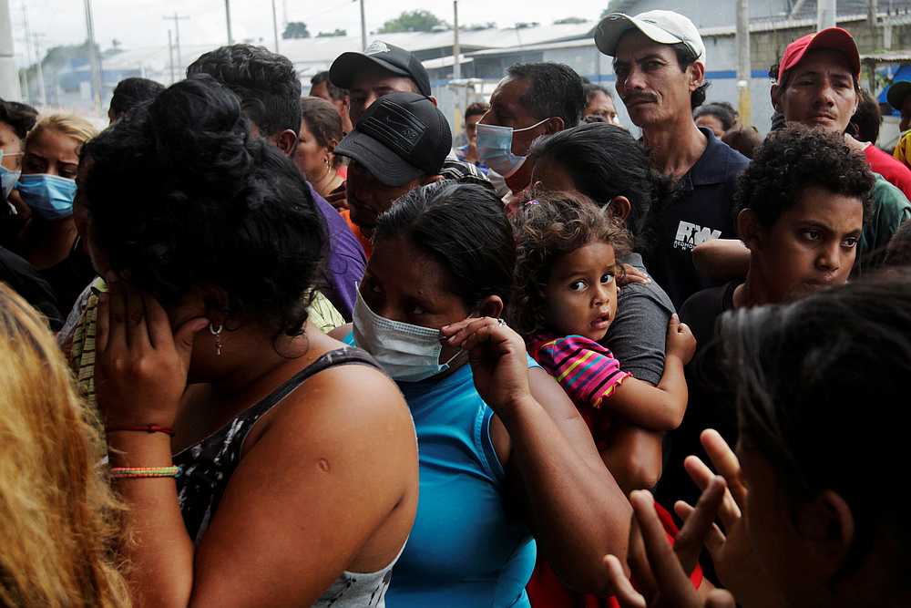 People queue for food under an overpass, where they are sheltered along with other residents due to floods and heavy rain brought by Storm Iota, in San Pedro Sula, Honduras November 19, 2020. u00e2u20acu201d Reuters pic