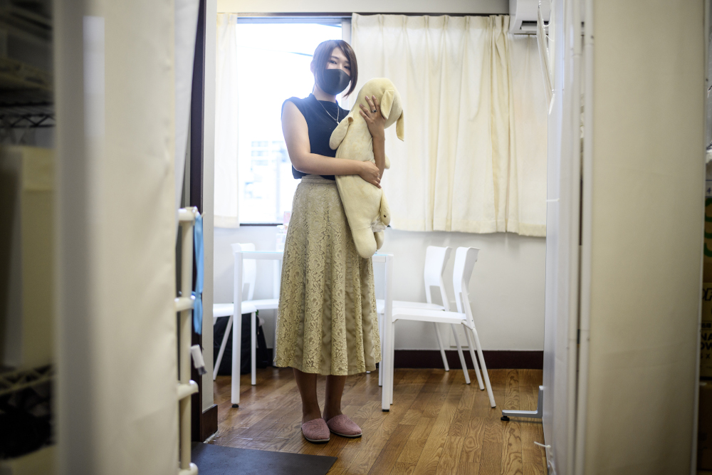 This photo taken shows client Yui Kato posing for a photo with her stuffed toy sheep Yuki-chan at Natsumi Clinic in Tokyo. — AFP pic 