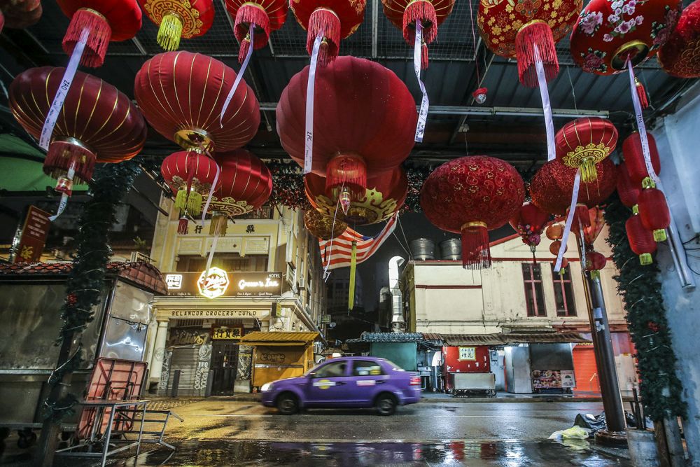 A taxi drives past a deserted Petaling Street duing the CMCO November 23, 2020. u00e2u20acu201d Picture by Hari Anggara
