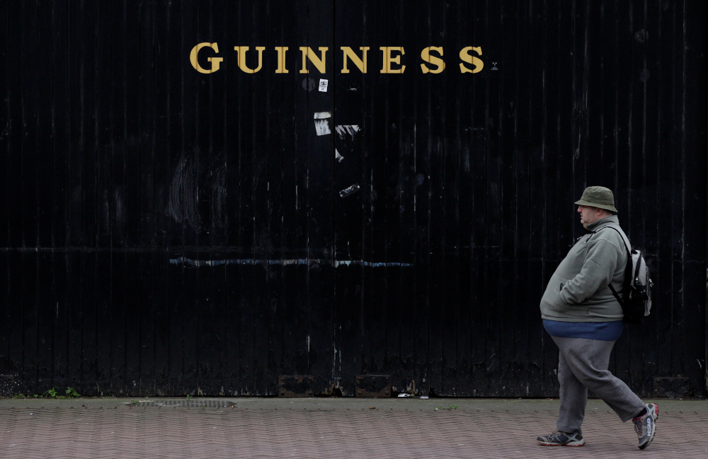A man passes the Guinness beer factory in the city centre of Dublin December 6, 2011. u00e2u20acu201d Reuters pic 