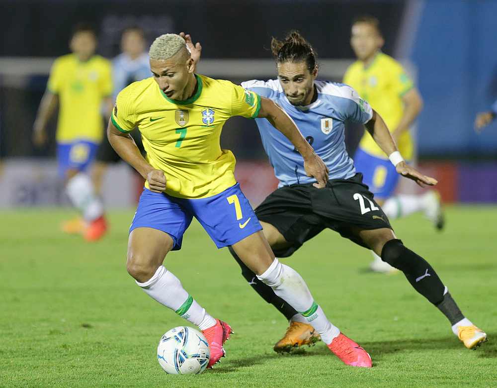 Brazil's Richarlison (left) in action with Uruguay's Martin Caceres in a World Cup South American qualifier at Estadio Centenario, Montevideo, Uruguay November 17, 2020. u00e2u20acu201d Pool pic via Reuters