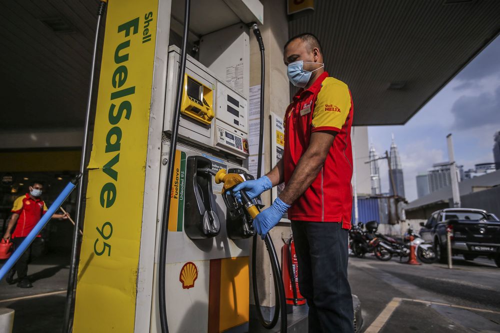 A petrol station attendant is seen in Chow Kit, Kuala Lumpur November 3, 2020. — Picture by Hari Anggara