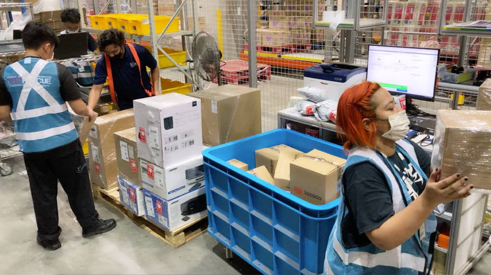 Workers packing and sorting high-valued items such as branded electronics at Lazadau00e2u20acu2122s warehouse in Singapore. u00e2u20acu201d Picture from Lazada via TODAYn