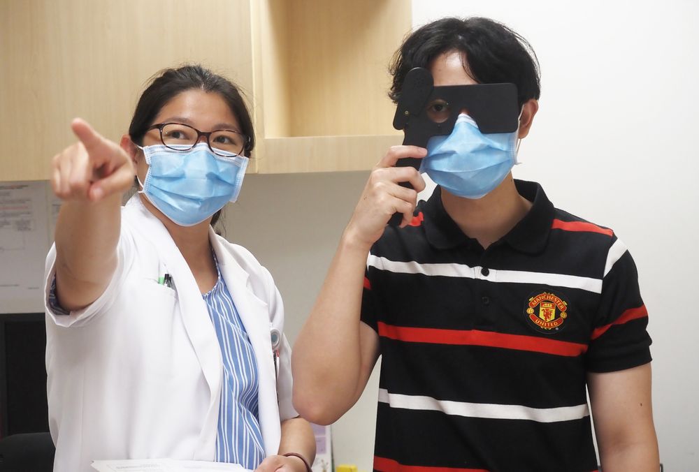 Senior occupational therapist Lim Hui Hui (left) assessing a client's visual ability to ensure that he meet the standards required to learn to drive. — Tan Tock Seng Hospital pic
