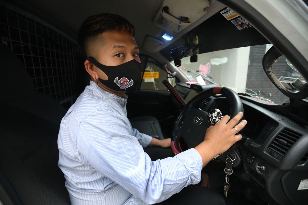 Khairul Khamari has residual weakness in his left upper limb after an accident and now drives using only one hand using a right spinner knob on the steering wheel of his van. — TODAY pic