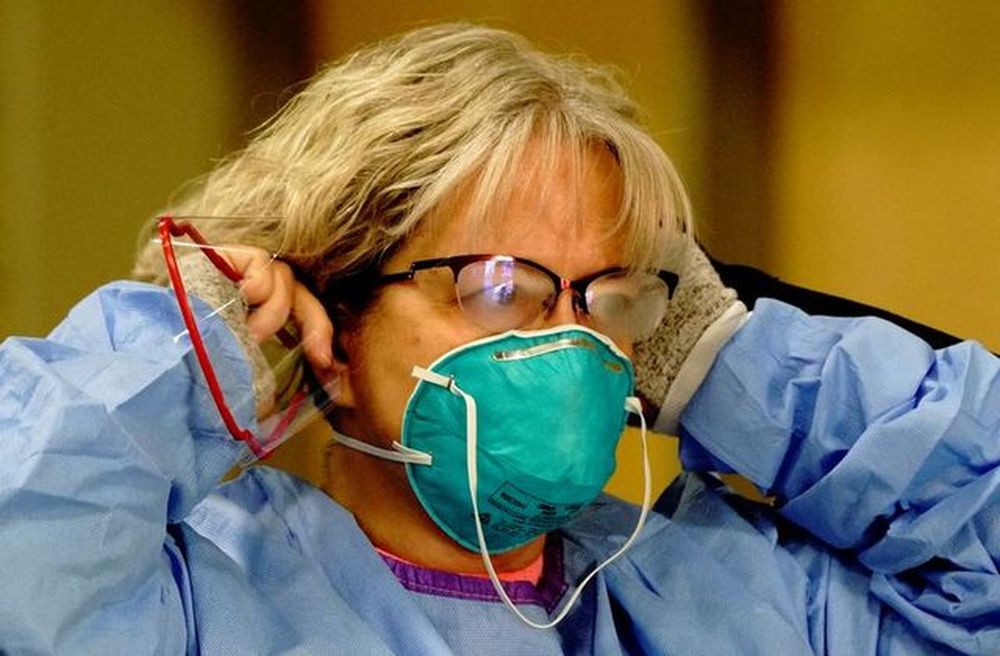 Registered nurse Dana Simmersu00e2u20acu2122 glasses fog up as she dons a 3M N95 protective mask before beginning her shift at a drive-thru testing site as the coronavirus disease outbreak continues in Bismarck, North Dakota, US, October 26, 2020. u00e2u20acu201d Reuters pic
