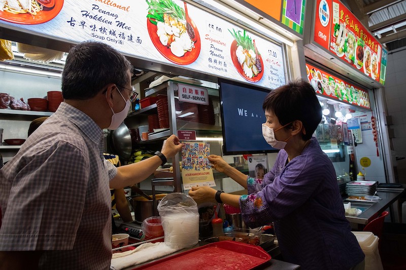 Edwin Tong (left), Minister for Culture, Community and Youth, and Grace Fu, the Minister for Sustainability and the Environment, visit the Ghim Moh food centre, December 17, 2020. — TODAY pic