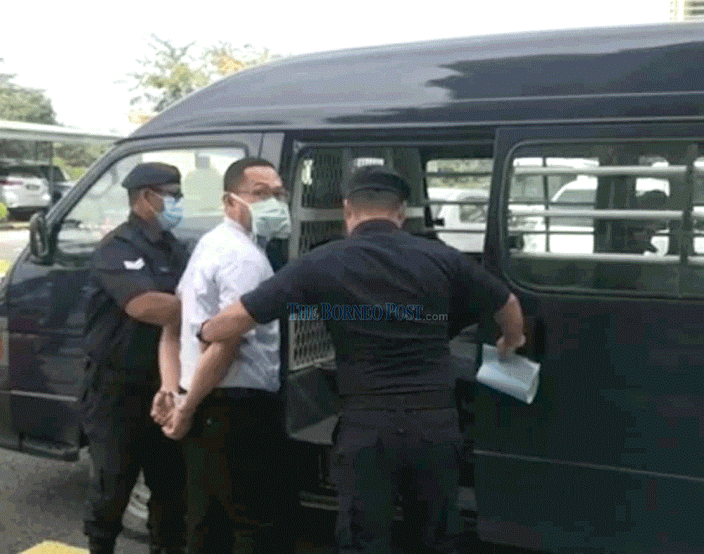 Wong being led from the courthouse by police following sentencing yesterday. u00e2u20acu201d Borneo Post Online pic