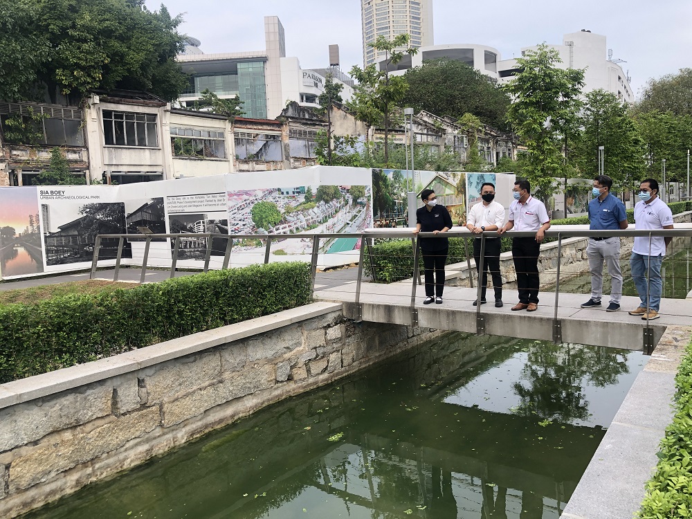 (From left) George Town World Heritage Incorporated general manager Ang Ming Chee, Pengkalan Kota assemblyman Daniel Gooi and Komtar assemblyman Teh Lai Heng visiting the Prangin Canal after the cleaning works and koi was reintroduced into the canal. u00e2u20acu201d 
