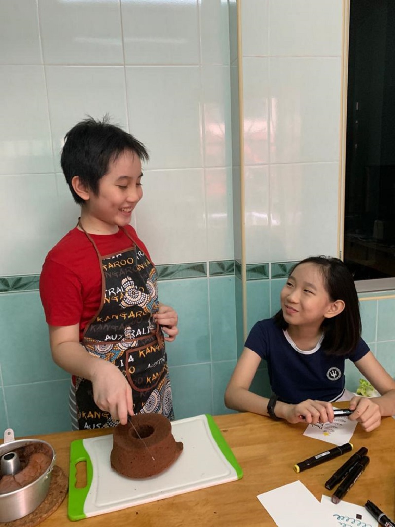 Kok (left) and his sister Emma Rose are working together to pull off the bake sale. — Picture courtesy of Ng Si Hooi