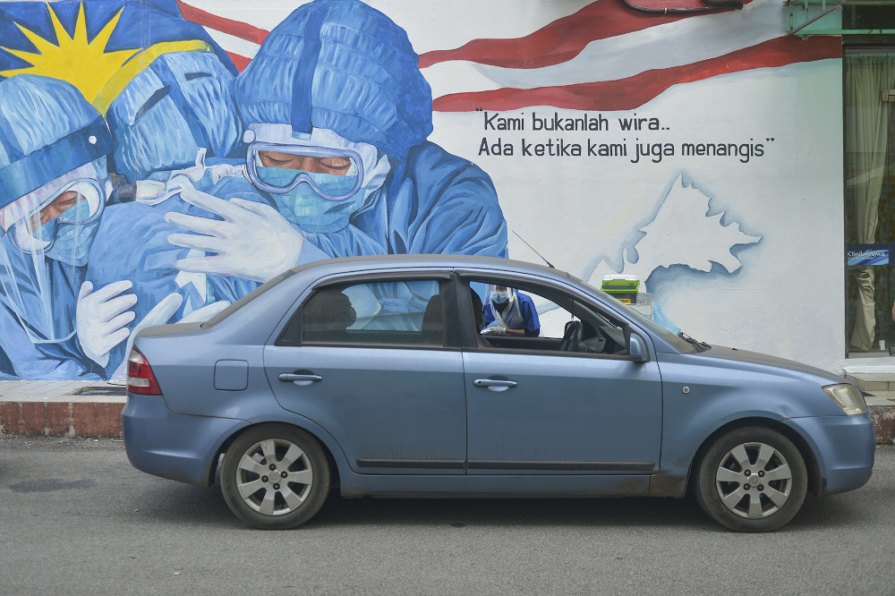 Klinik Ajwa health officers take samples and information from the public during Covid-19 screening in Shah Alam December 10, 2020. u00e2u20acu201d Picture by Miera Zulyana 
