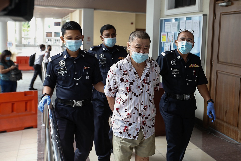 Ong Lai Seng is led by police to the Georgetown Magistrate Court December 11, 2020. u00e2u20acu201d Picture by Sayuti Zainudin 