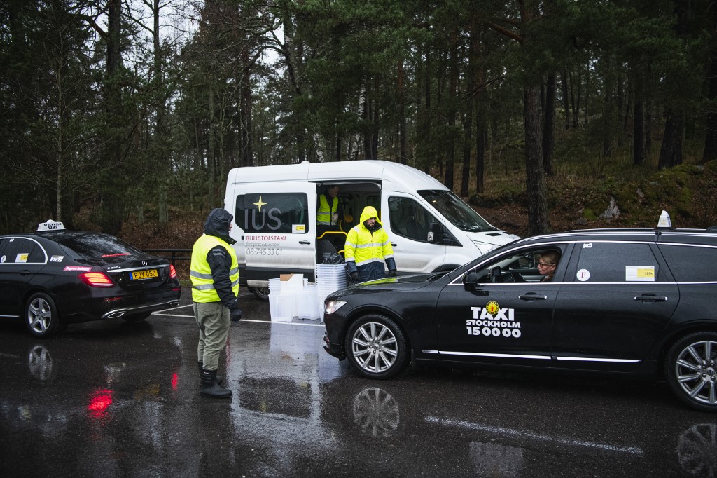 A Taxi Stockholm driver returns PCR tests for processing after collecting them from people who suspect they have Covid-19, on December 4, 2020 in a suburb of Stockholm, Sweden. u00e2u20acu201d AFP pic