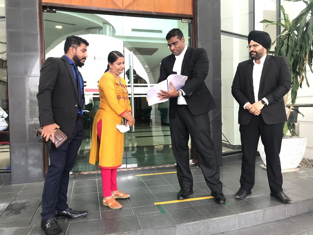 Lawyers Rajesh Nagarajan (second right) and Sachpreetraj Singh Sohanpal (right) explaining the High Courtu00e2u20acu2122s order to M. Indira Gandhi, who was accompanied by Indira Gandhi Action Team chairman Arun Dorasamy. u00e2u20acu201d Picture by John Buny