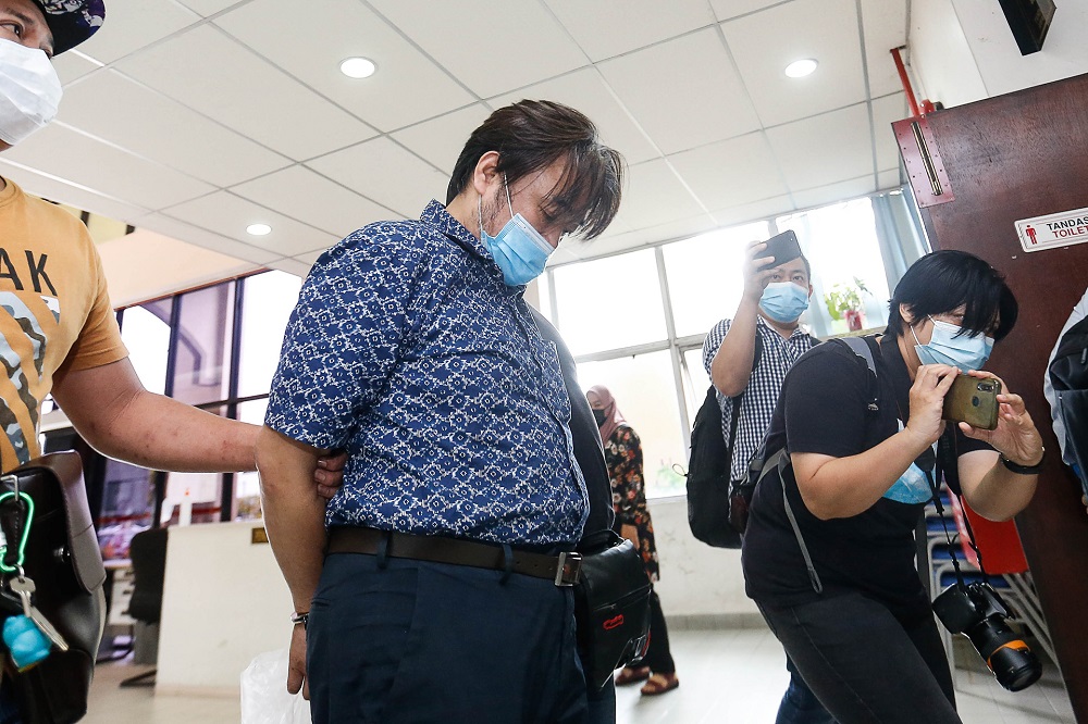 Jee Jon-hoon is led in cuffs to the Butterworth Court Complex December 18, 2020. u00e2u20acu201d Picture by Sayuti Zainudin