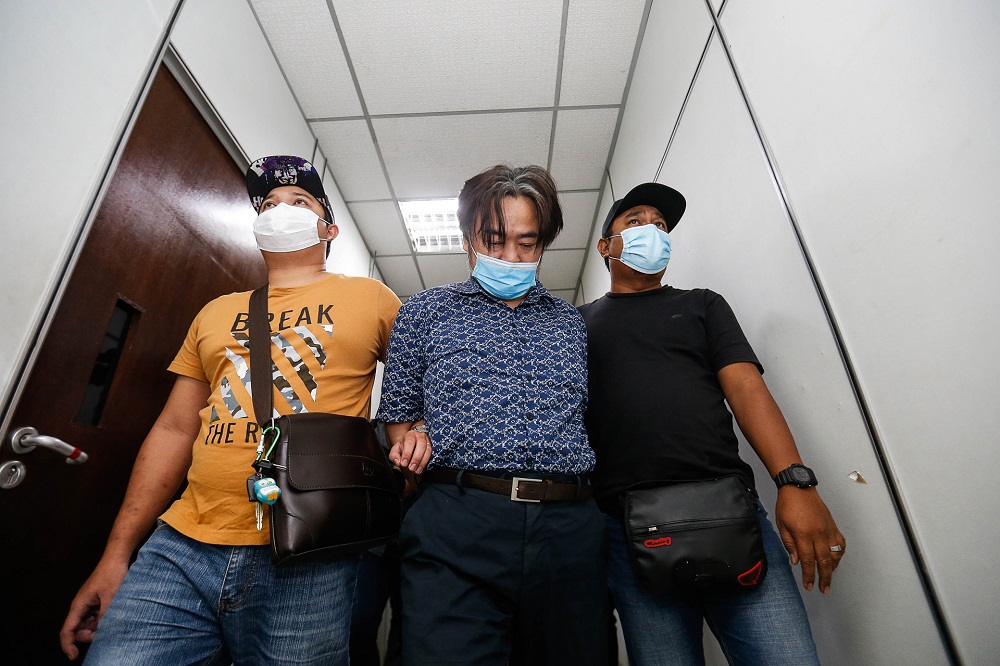 Jee Jon-hoon is led in cuffs to the Butterworth Court Complex December 18, 2020. u00e2u20acu201d Picture by Sayuti Zainudin