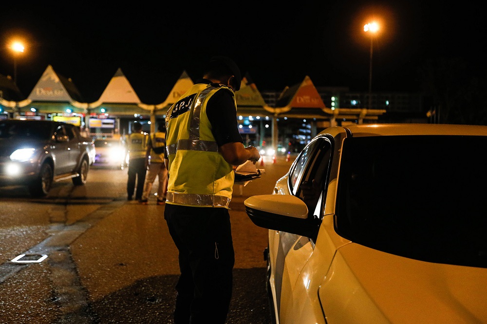 Road Transport Department personnel are seen at a roadblock at the Juru Toll Plaza in Simpang Ampat December 18, 2020. u00e2u20acu201d Picture by Sayuti Zainudin