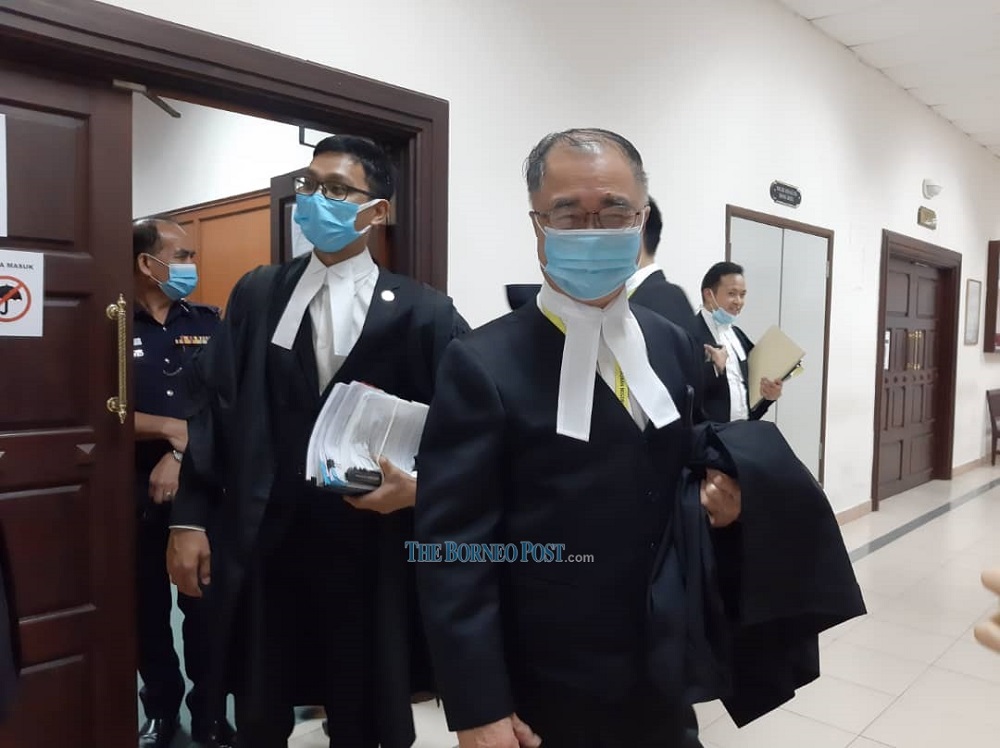 State Legal Counsel Datuk JC Fong (right) and legal officer Mohd Adzrul Adzlan (left) leaving the courtroom in Kuching December 18, 2020. u00e2u20acu201d Borneo Post Online pic