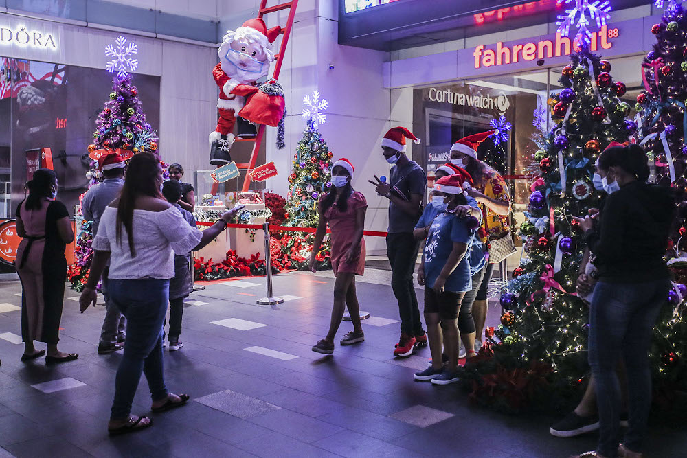 Shoppers dressed in Christmas outfits are seen in front of the Pavilion Kuala Lumpur December 24, 2020. u00e2u20acu201d Picture by Hari Anggara