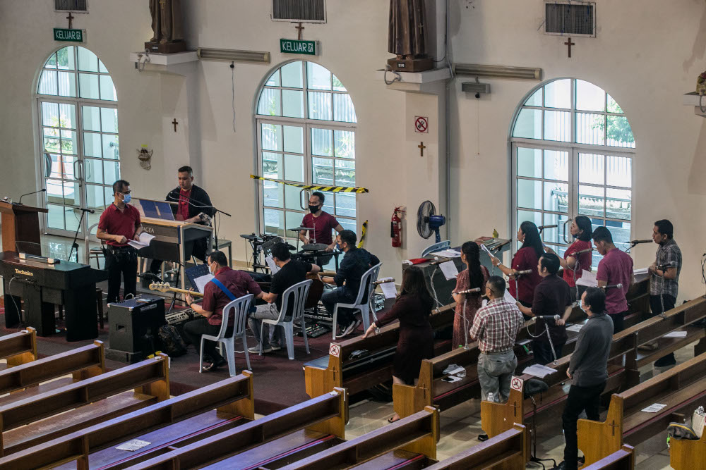 Church choir is limited to a selected few as Christmas Mass is conducted without the presence of churchgoers in respect of congregation limit restrictions imposed by the government at the Church of Divine Mercy December 25, 2020. — Picture by Firdaus La