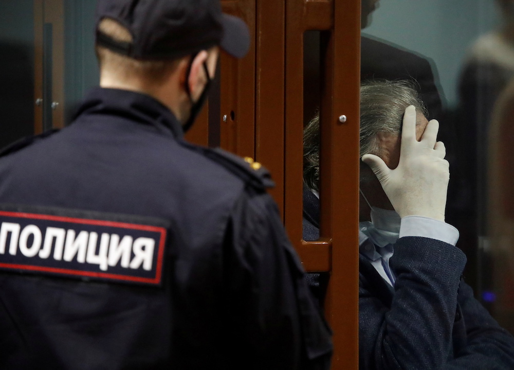 Russian historian and professor Oleg Sokolov, who is accused of murdering his partner and former student, reacts inside a defendants' cage during a court hearing in Saint Petersburg, Russia December 25, 2020. u00e2u20acu201d Reuters pic