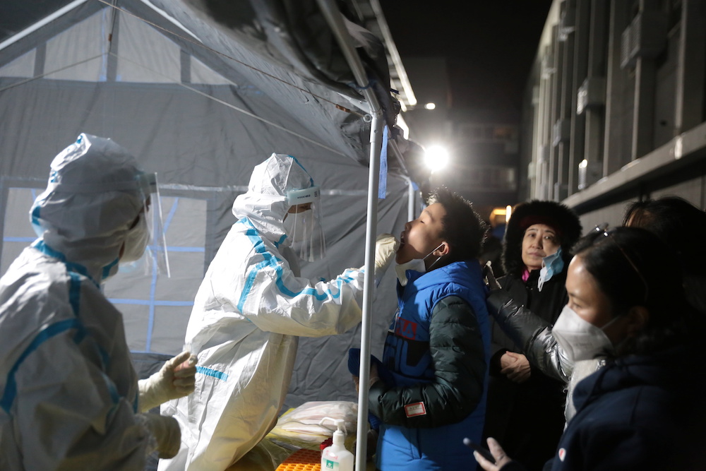 A medical worker in protective suit collects a swab from a resident for nucleic acid testing, following new cases of coronavirus disease (Covid-19) in Beijing, China December 24, 2020. u00e2u20acu201d Reuters pic