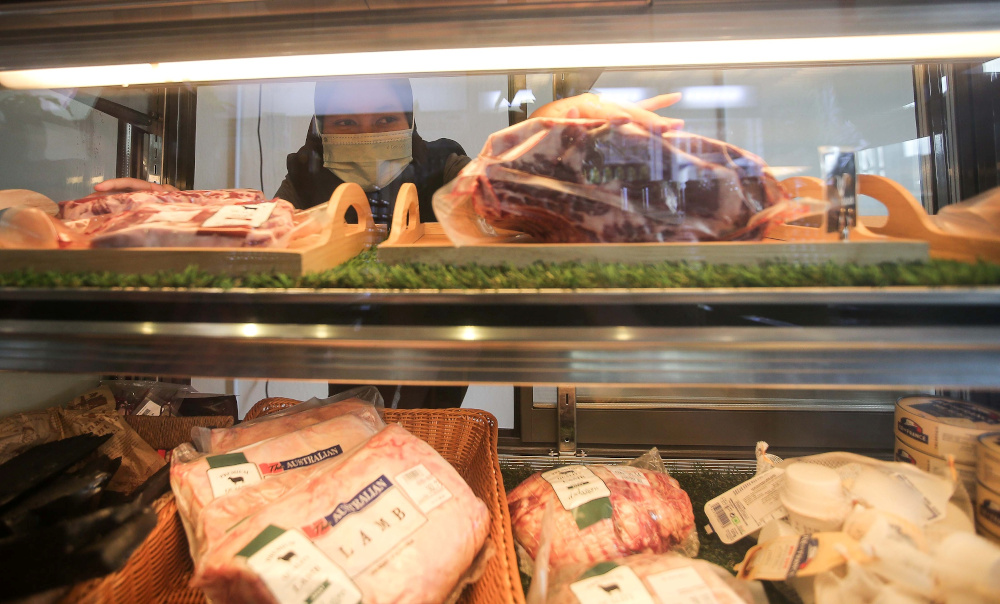 A worker arranging imported frozen meat at a meat shop in Ipoh December 28, 2020. News of imported meat that was improperly sourced and passed off as halal recently made headlines. u00e2u20acu201d Picture by Farhan Najib