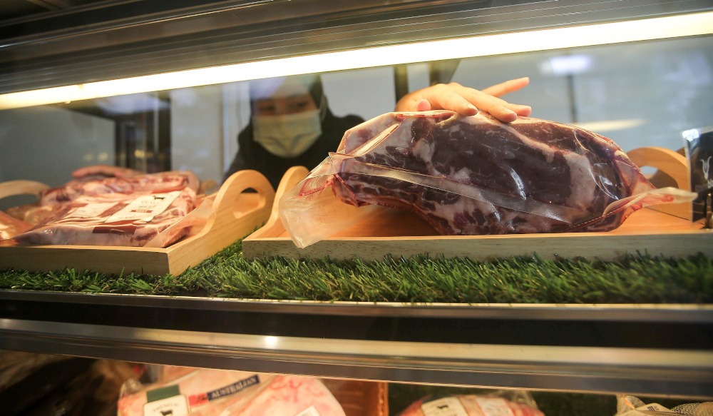 A worker arranging imported frozen meat at a meat shop in Ipoh December 28, 2020. News of imported meat that was improperly sourced and passed off as halal recently made headlines. u00e2u20acu201d Picture by Farhan Najib