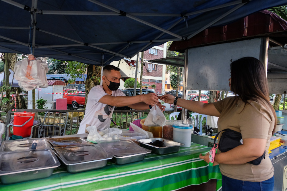 Food vendor Wan Iqhwan works in his roadside stall in Kuala Lumpur December 28, 2020. u00e2u20acu201d Picture by Yusof Mat Isa