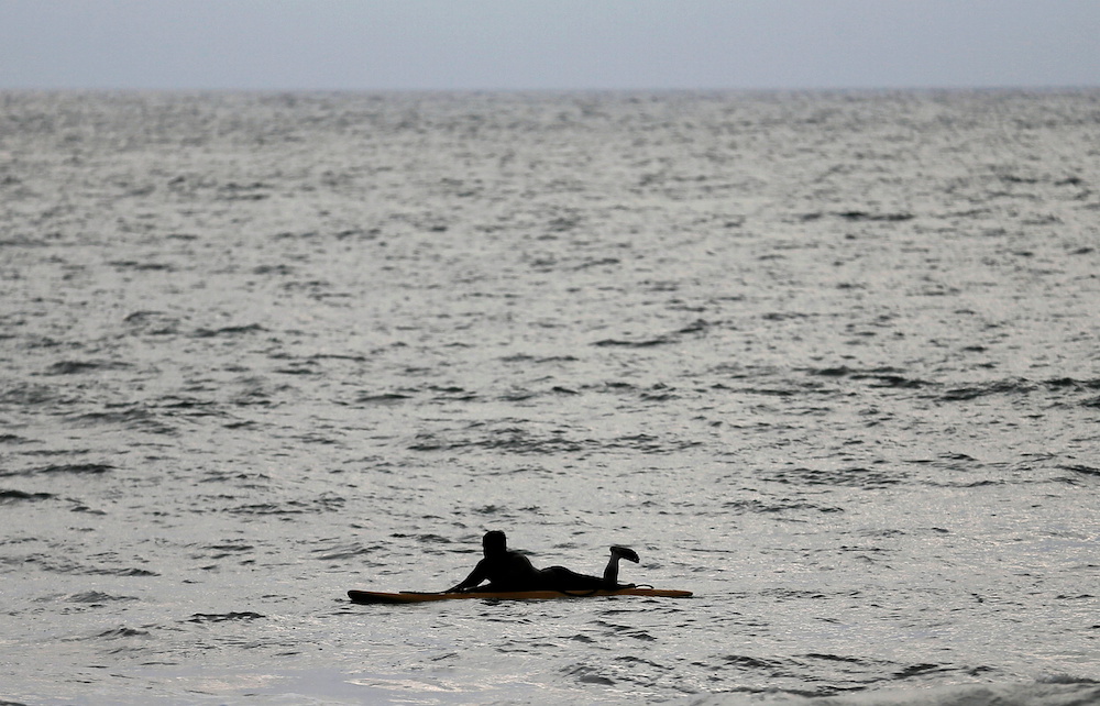 A man floats on a top of a surfing paddle in the sea in Colombo, Sri Lanka, December 10, 2020. u00e2u20acu201d Reuters pic