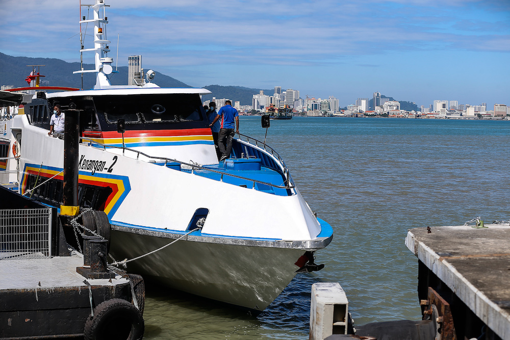 The new fast boat which will be replacing the old ferry service is pictured docked at Swettenham Pier, December 28, 2020. u00e2u20acu201d Picture by Sayuti Zainudin