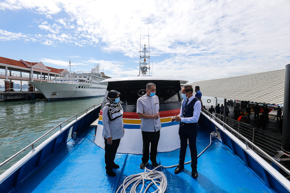 (from left) Penang Port Commission General Manager Monaliza Suhaimi, Penang Port Commission Chairman Datuk Tan Teik Cheng and Penang Port Chairman Datuk Syed Mohamad Aidid Syed Murtaza on the new fast boat, December 28, 2020. — Picture by Sayuti Zainudi