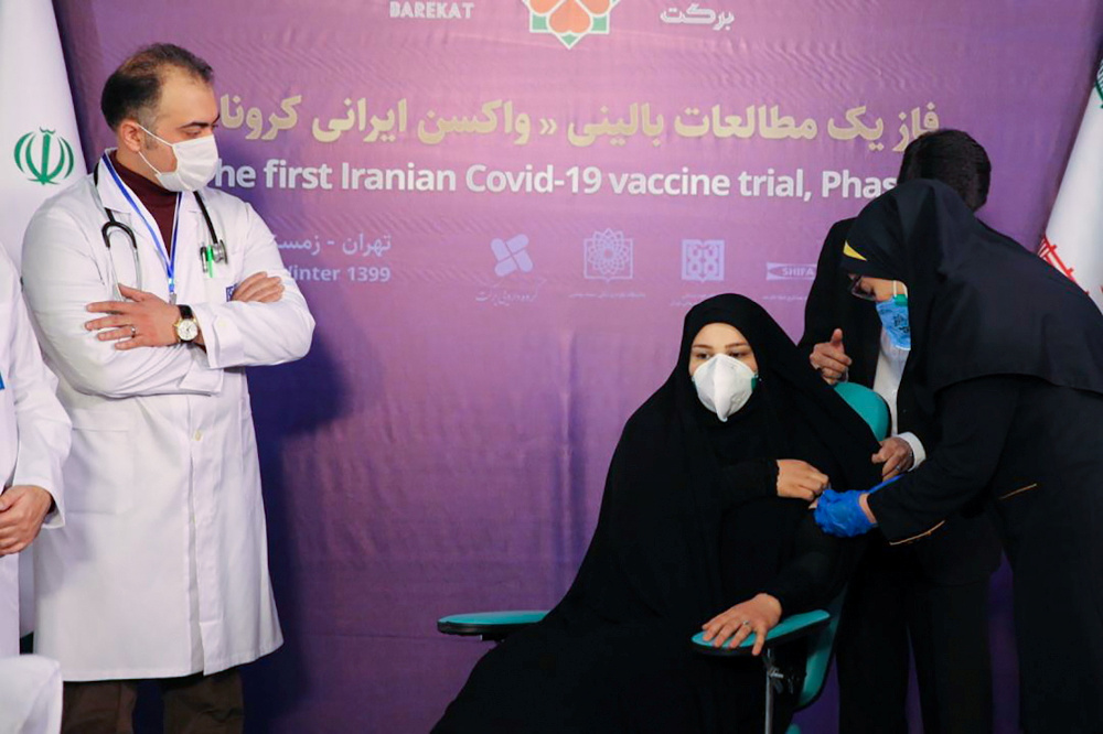A nurse prepares to inject a volunteer taking part in an Iranian coronavirus disease vaccine trial in Tehran, Iran December 29, 2020. u00e2u20acu201d Organisation of the Execution of Imam Khomeiniu00e2u20acu2122s Order/WANA (West Asia News Agency) handout pic via Reutersnn