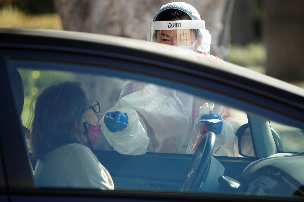 A healthcare worker at LAC USC Medical Center tests a person at a drive through testing centre during the outbreak of the coronavirus disease in Los Angeles, California, December 10, 2020. u00e2u20acu201d Reuters picnn