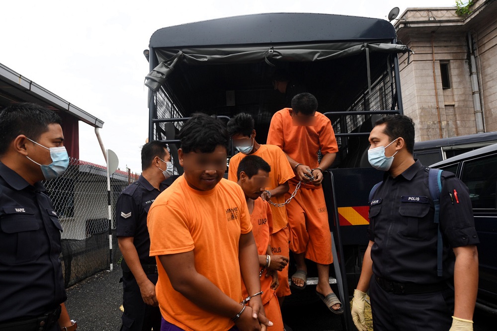 The suspects are led out of the Kangar Magistrate Court November 26, 2020. u00e2u20acu201d Bernama pic
