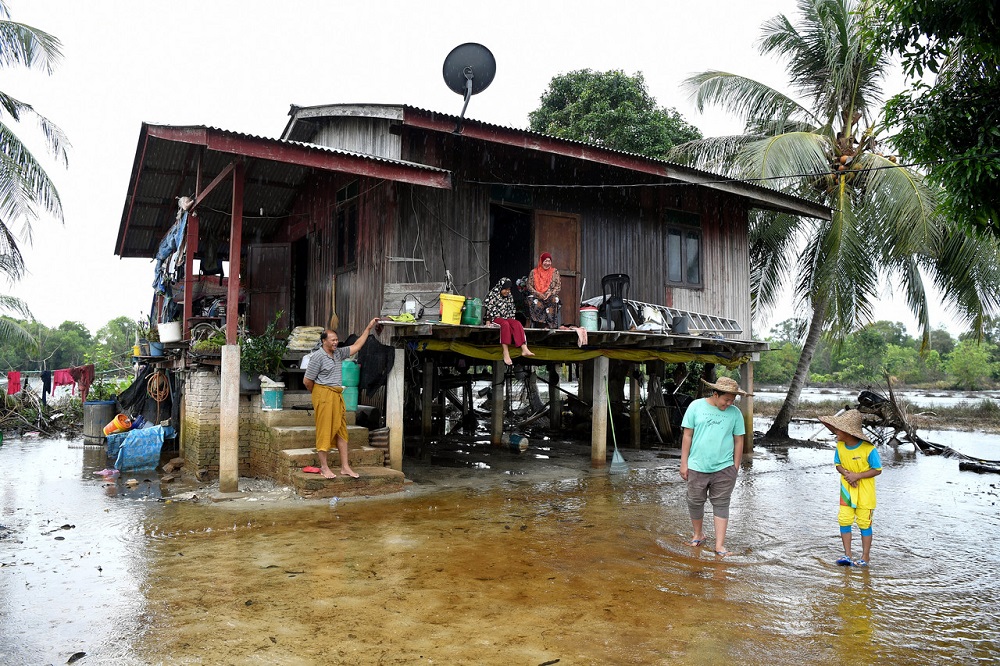 Flood victims are seen outside their home in Marang December 8, 2020. u00e2u20acu201d Bernama pic