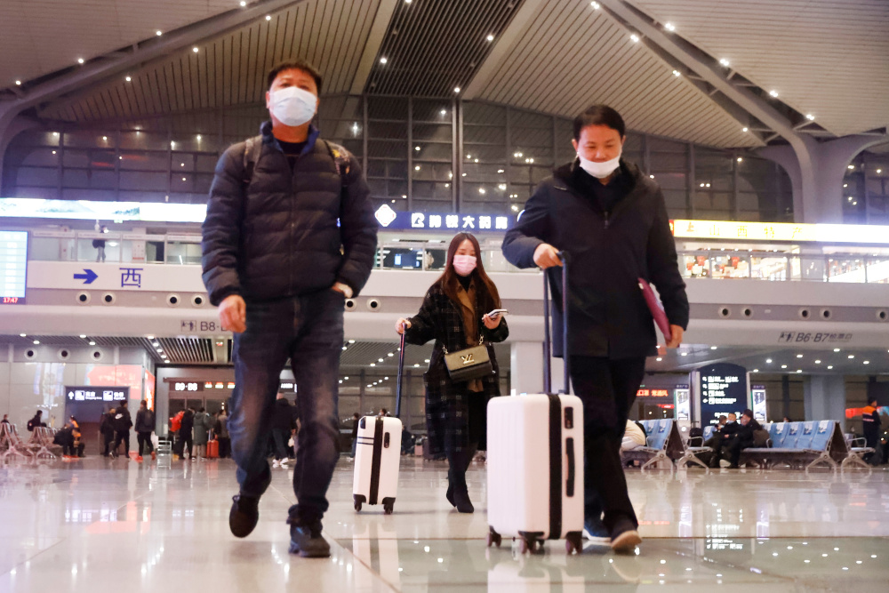 People wearing face masks walk inside a high speed train station, following the coronavirus disease outbreak in Taiyuan, Shanxi province, China December 2, 2020. u00e2u20acu201d Reuters picnn
