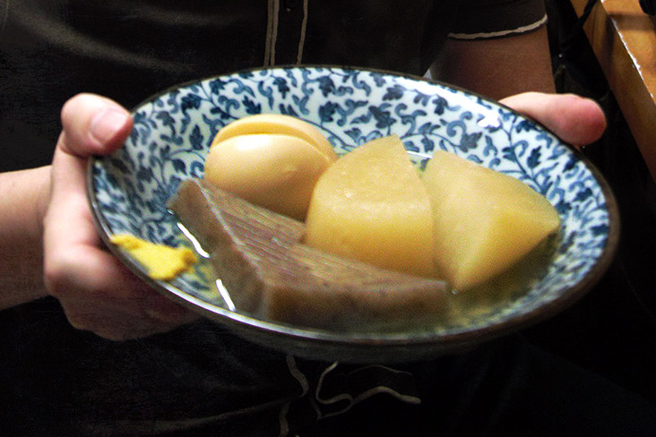 'Oden' served in a light 'dashi' broth with 'karashi' (yellow mustard) as a condiment.